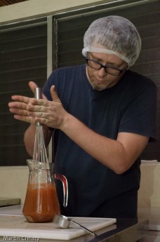 Carlos Mann making traditional chocolate drinks